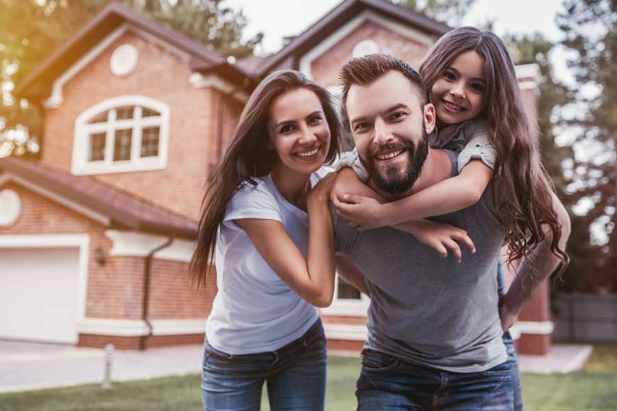 A family of three outside their new home - Keep termites away from your new home with SOS Exterminating in Gilbert AZ