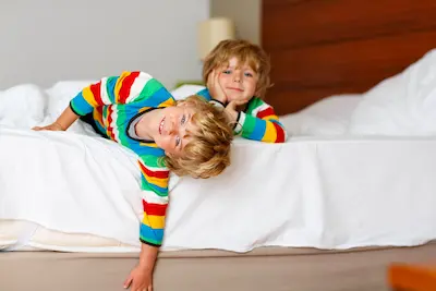 Two little sibling kid boys having fun in bed | SOS Exterminating serving Gilbert, Arizona
